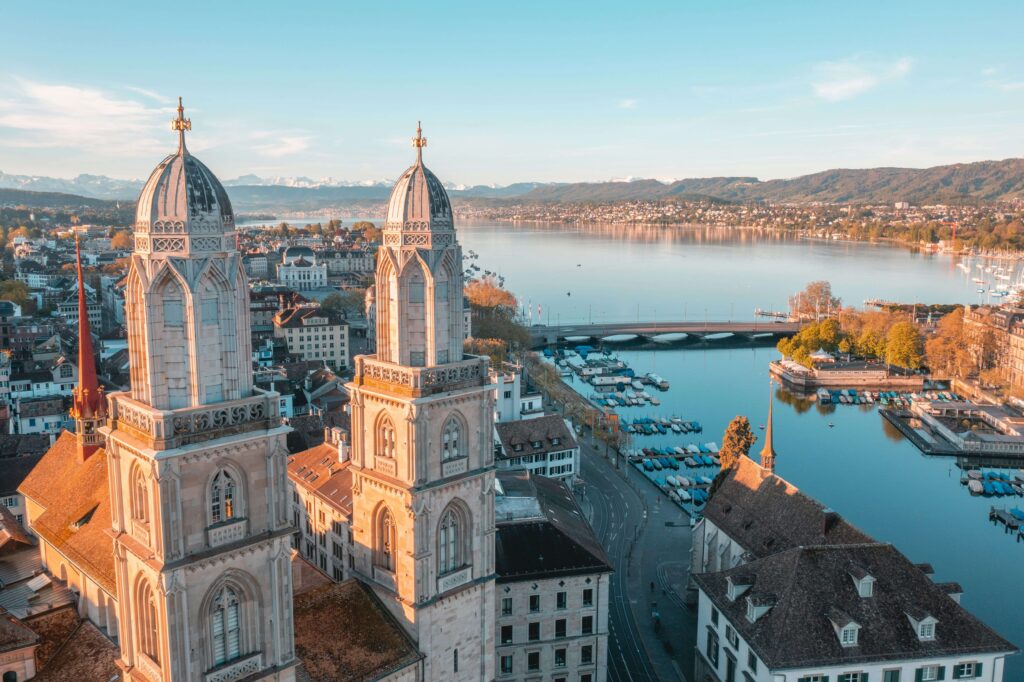 Aerial view of Zurich’s Grossmünster towers and Lake Zurich at sunrise — symbolic for Zurich Marathon 2025 nutrition planning and race preparation.