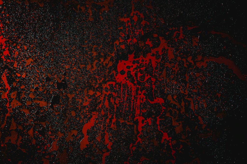 Abstraktes Hintergrundbild mit roten fließenden Formen auf dunklem Untergrund – symbolische Darstellung von Blut, Eisen und Energiehaushalt.